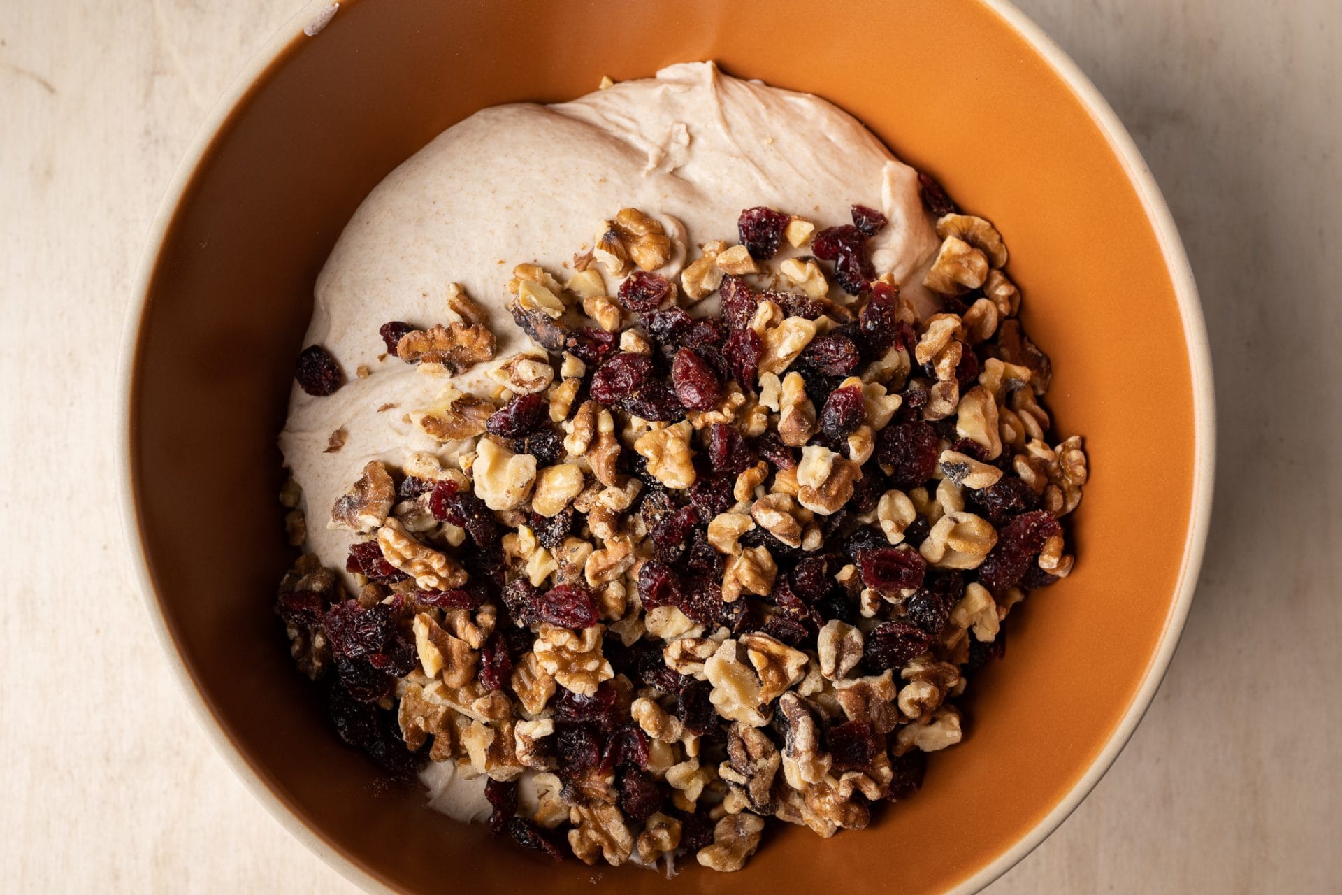 walnuts and cranberries on top of sourdough dough