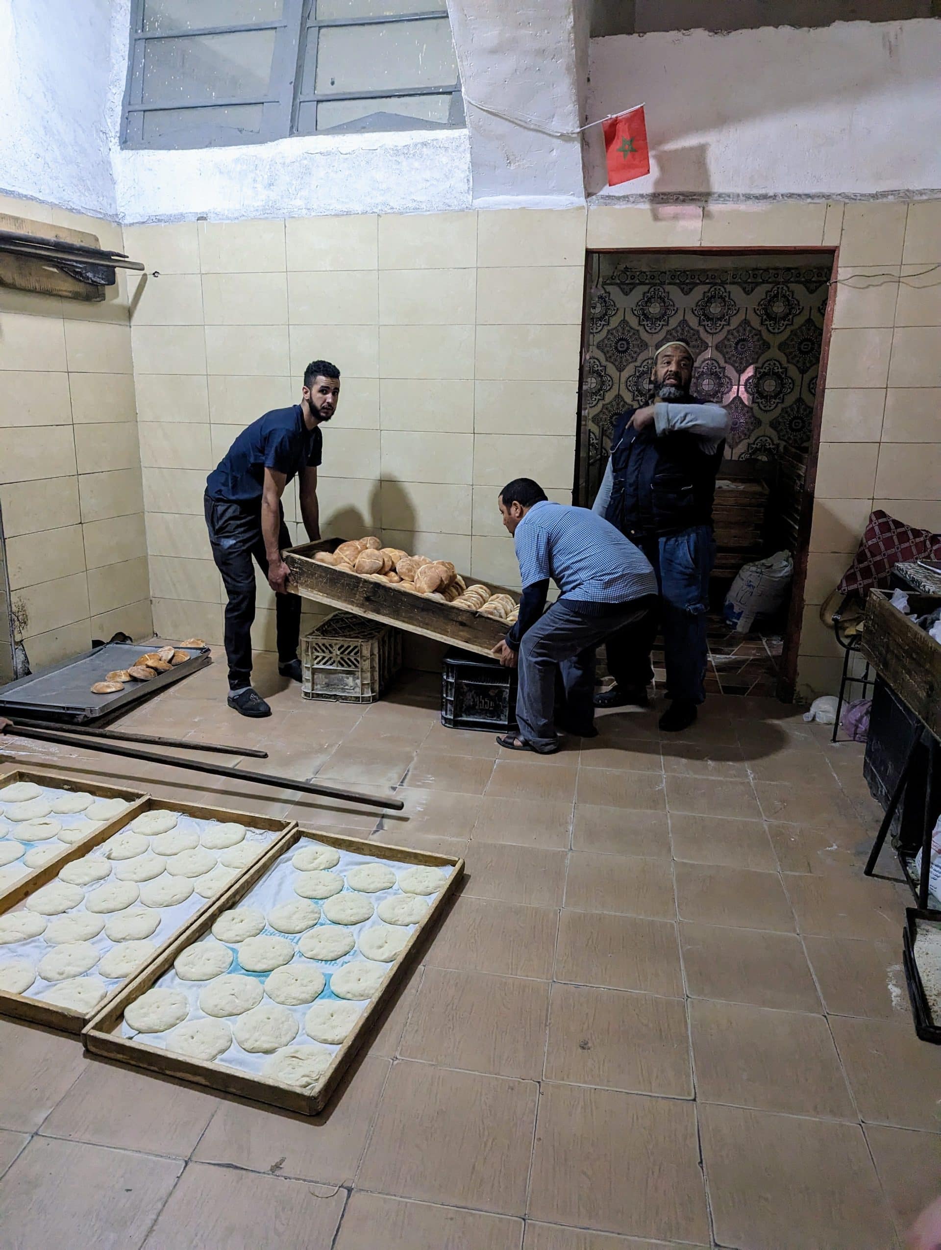 Carrying bread up to street level for delivery in Morocco.