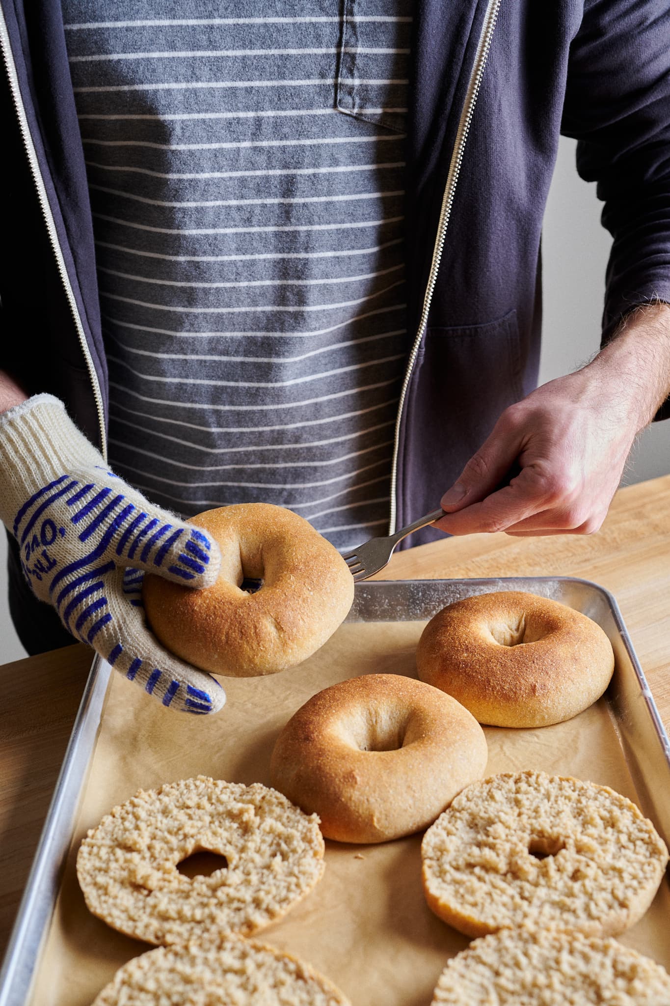 Using a fork to split the sourdough friselle.