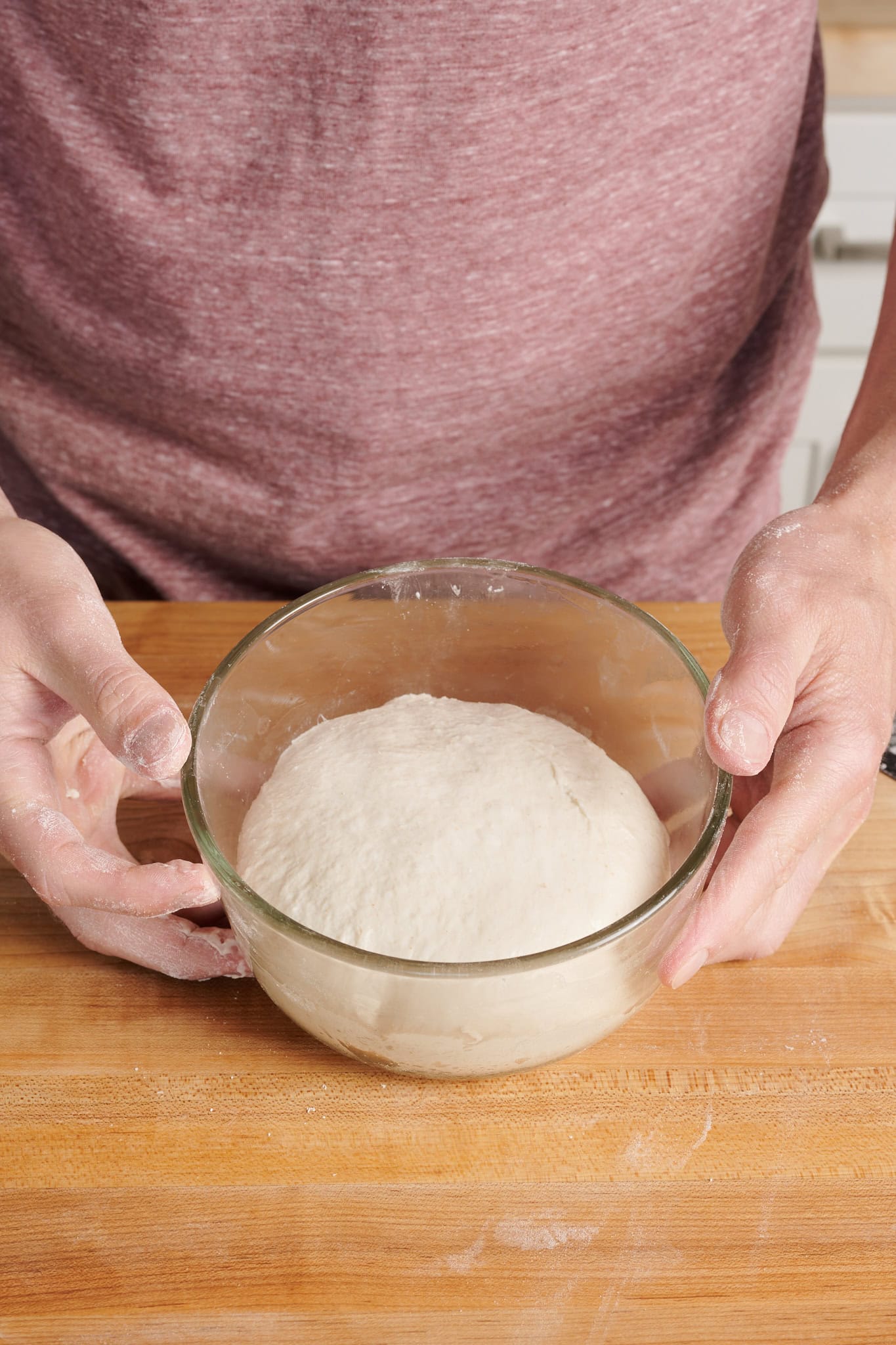 Detroit-style pizza dough in proofing container.