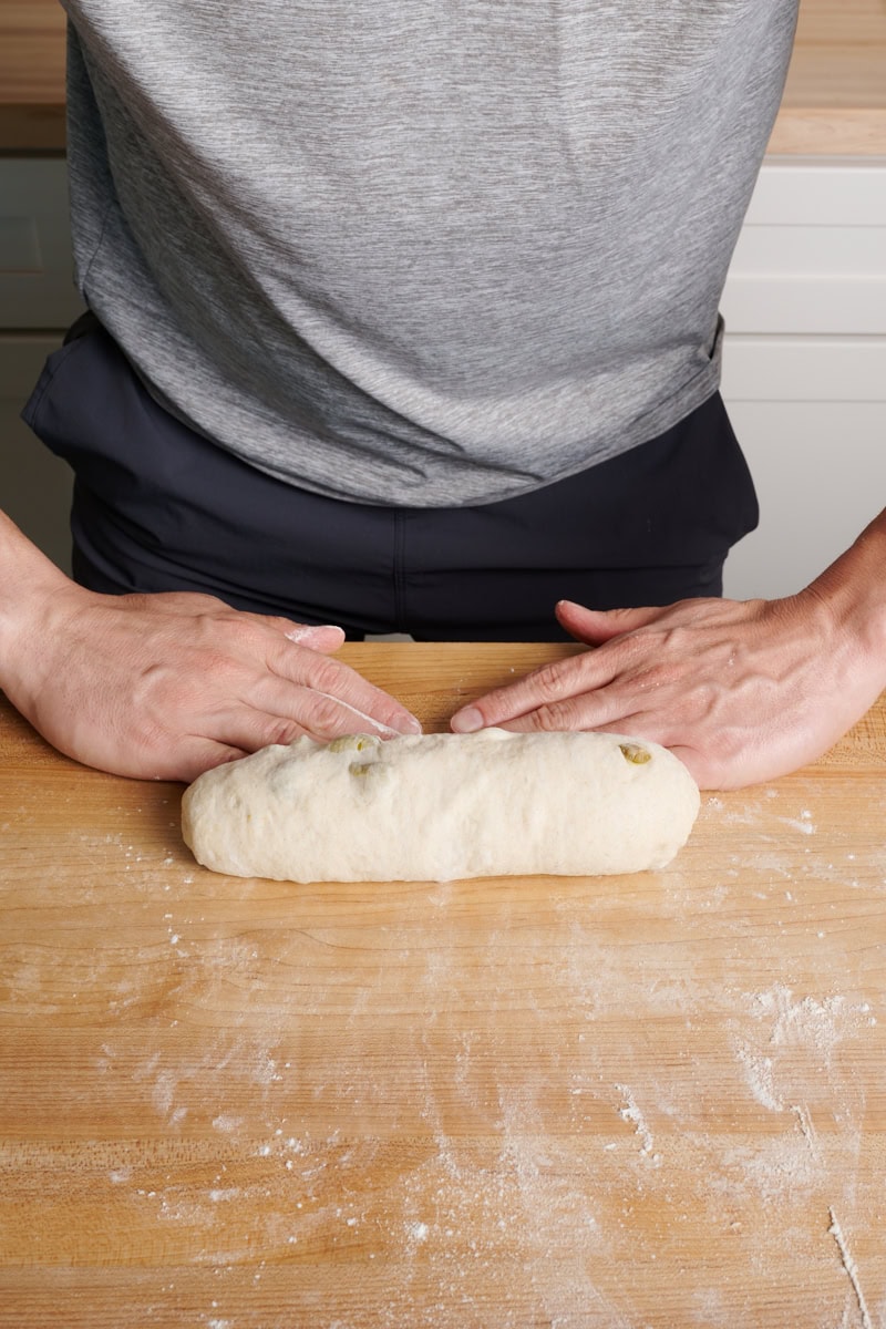 The third step to shaping filoncini is to roll the dough into a tight tube.