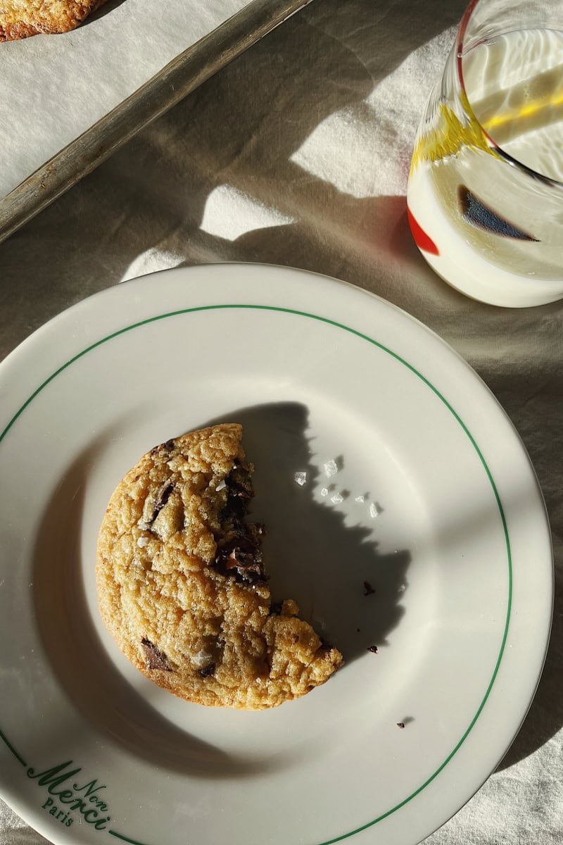 A bitten sourdough starter discard chocolate chip cookie.