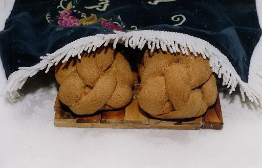 Challah beneath its traditional challah cover.