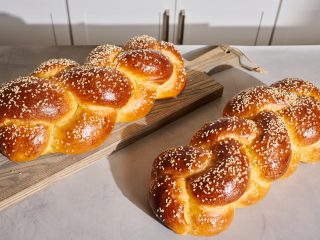 Braided sourdough challah on a table.