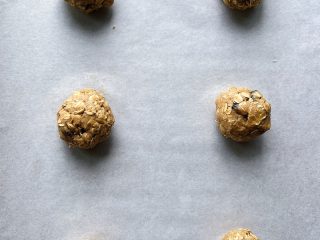 Balled oatmeal raisin cookie dough.