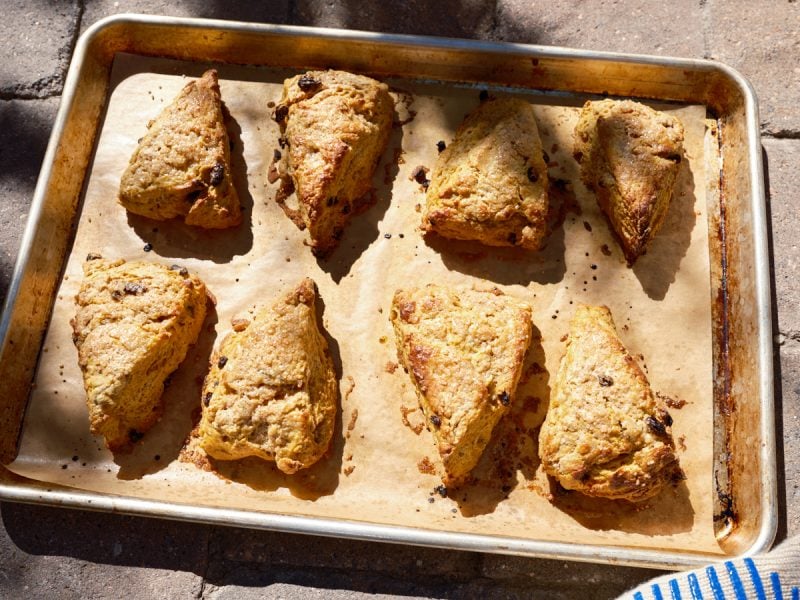 Sourdough pumpkin scones on a baking sheet.