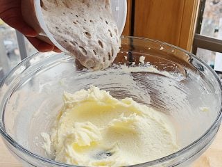 Adding sourdough starter discard to the cinnamon toast cookie batter.