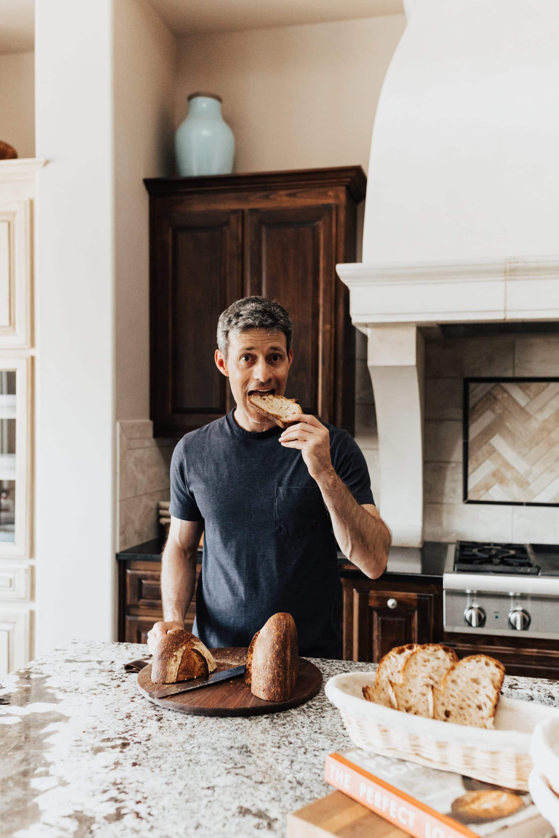 Maurizio Leo eating a slice of sourdough bread.